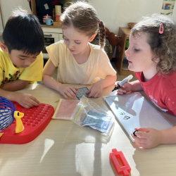 Lorenzo, Esme and Paige having fun with bingo .
