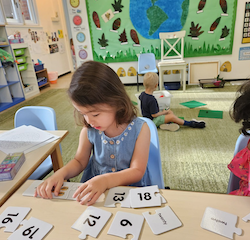 Myla having fun with numeracy game, recognising number.