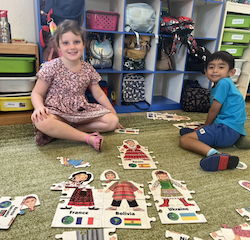 Paige and Lorenzo enjoying puzzle time .