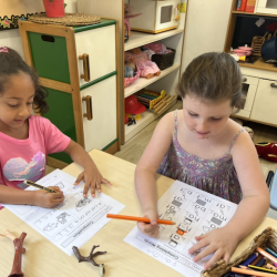 Paige and Reina completing their writing activity.