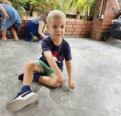Rowan getting creative with chalk.