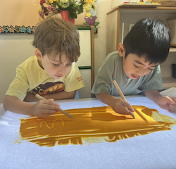 Wilbur and Lorenzo practicing their writing using sand .