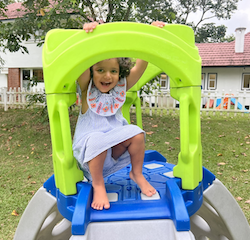 Big smiles from Una at the top of the slide!