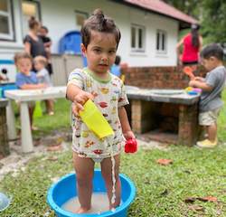Milan fully embracing the mud kitchen! In he goes!