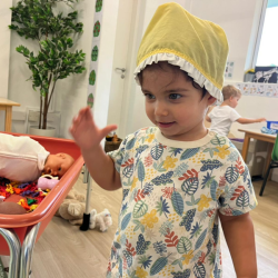 Milan trying on the babies hat.