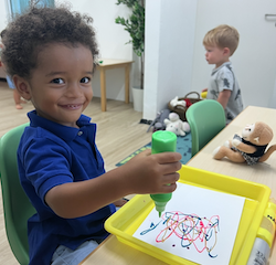 Teddy painting his butterflies.