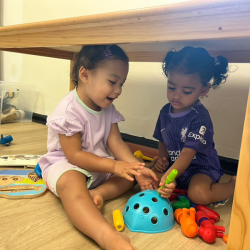 Alba and Imaan enjoying playing under the table!