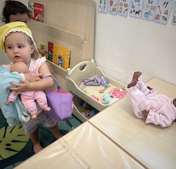 Charlotte trying on the baby’s clothes!