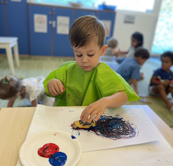 Jasper mixing colours and painting with a car.