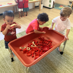 Nate, Amara and Leo enjoying the red sensory bin!