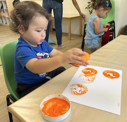 Otto painting with a mandarin orange!