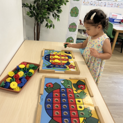 Alba enjoying the peg board!