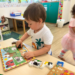 Alexander enjoying the farm animal puzzles!