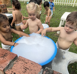 Imaan and Luca scooping up all the bubbles!