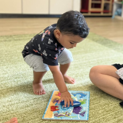Kavi matching the shark on the puzzle!