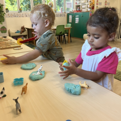 Kingston and Imaan enjoying pressing farm animals into Playdoh!