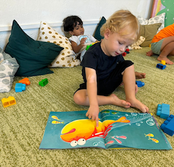 Kingston enjoying reading a book and spotting all the sea animals. Fish!'