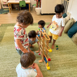 The boys watching the cars go down the track!