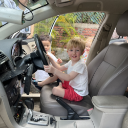 Asher is having a feel of the police car