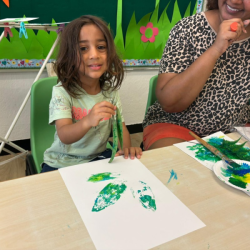 Artie is proud of his leaf painting.
