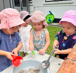 Having fun in the mud kitchen.