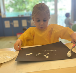 Annabel is working on her toothbrush art.