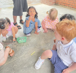 Colouring and drawing with chalk on the first day of school.