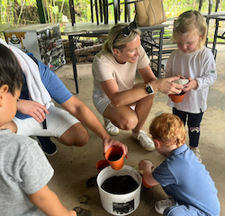 Izzy, Niko and Sebastian are planting baby pandan.