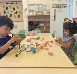 Niko and Nila are stringing beads.