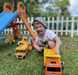 Sebastian loves playing with trucks!
