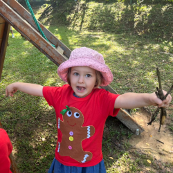 Victoire is collecting some sticks in the garden.