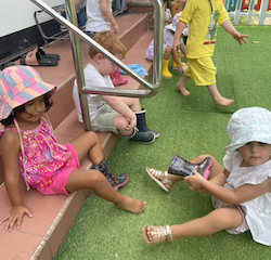 Victoire volunteered to help Ruhi with her boots.