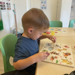 Archer is focused on  his animal puzzle.