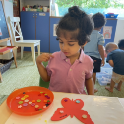 Archish is working on his butterfly art project.