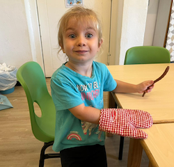 Chef Annabel is ready for her muffins to come out of the oven.