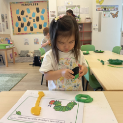 Ellie is playing with green play dough