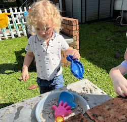 Having fun in the mud kitchen.