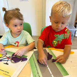 Indie and Marceli making cars and rockets with play dough.