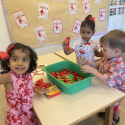Playing with our CNY sensory bin.