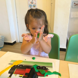 Tahlia squishing the play dough. 