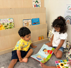 Una and Kai are reading together.