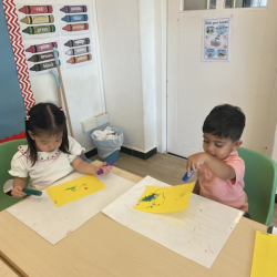 Kai and Maya getting creative with paint sticks.