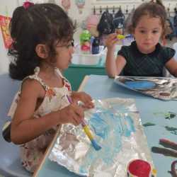 Painting waves on foil.