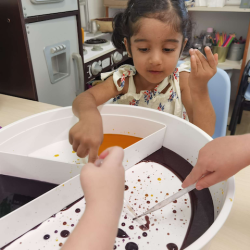 Practising our fine motor skills by moving the water beads.