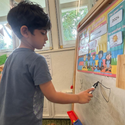 Practising the letter sounds.