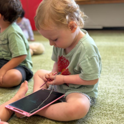 Arthur having a go with the LCD drawing pads!