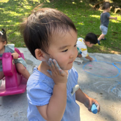 Cara enjoying getting messy during chalk drawing!