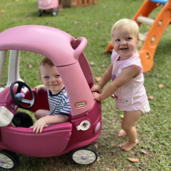 Eleanor and Arthur taking turns to push each other in the play car!