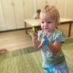 Eleanor loved playing with the feathers!.