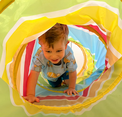 Jasper crawling through the gym tunnel!